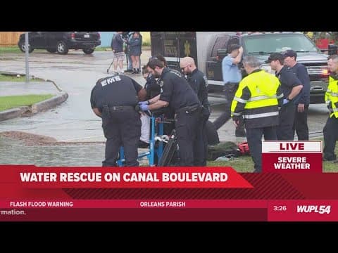 Two men rescued from car during street flooding on Canal Blvd.