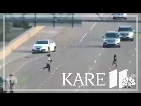 WATCH: Two people run across I-35E to escape police