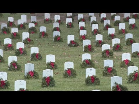 Volunteers prepare to place thousands of wreaths at Arlington National Cemetery Saturday