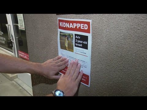 Volunteers post flyers of people kidnapped by Hamas to spread awareness