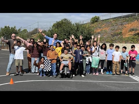 Fourth-grade student races a wheelchair on his elementary school's custom racetrack