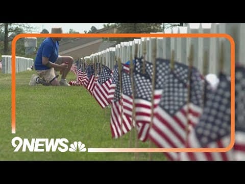 Volunteers place flags at Fort Logan National Cemetery
