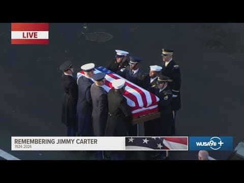 Band plays "Hail to The Chief" as Carter's casket is transferred to horse-drawn Caisson