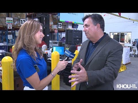 Brian Greene, president of the Houston Food Bank gives meteorologist Kim Castro a tour