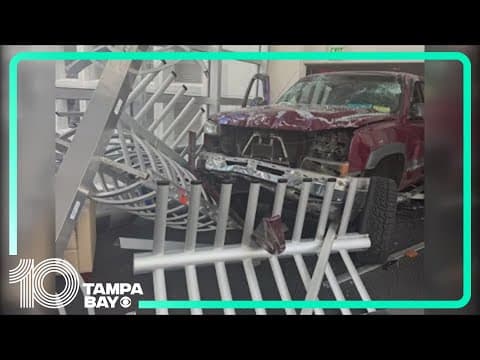 Driver detained after truck crashes into Tampa bank