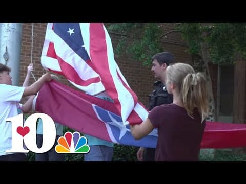 Loudon County students being taught how to properly raise and lower the American flag by Sheriff's D