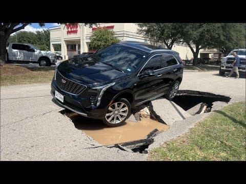 Look: SUV tips into sinkhole in northwest Harris County