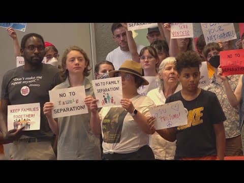 Over 100 people gather for silent ICE protest during city council meeting