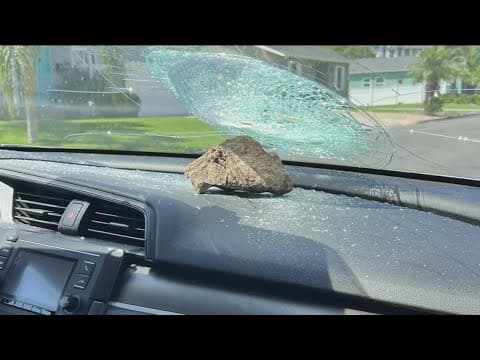 Rock thrown at moving car smashes driver's windshield