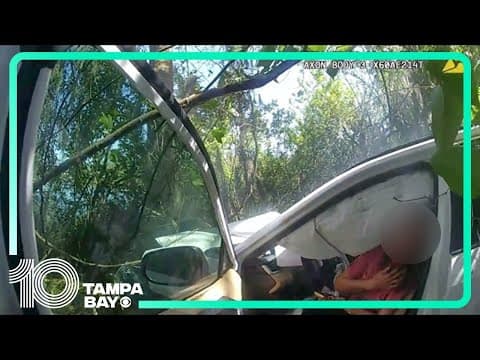 Woman pulled from car moments before it goes up in flames after crash