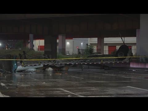 18-weeler dangles over a bridge in Downtown Dallas