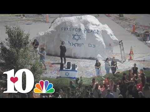 UT students showing support for lives lost in Israel by painting famous rock