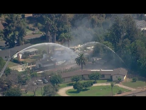 Authorities respond to burning home in El Cajon, possible armed suspect on the property