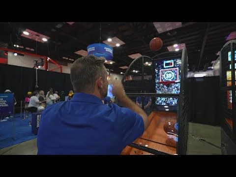 13News anchor Dustin Grove shoots hoops during WNBA Live in Indianapolis