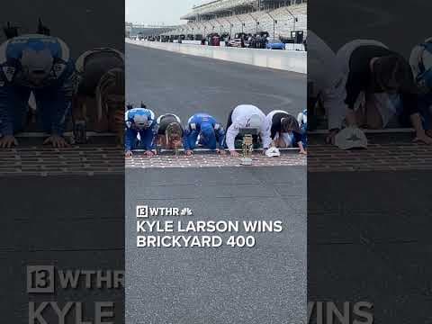Kyle Larson kisses the bricks at IMS