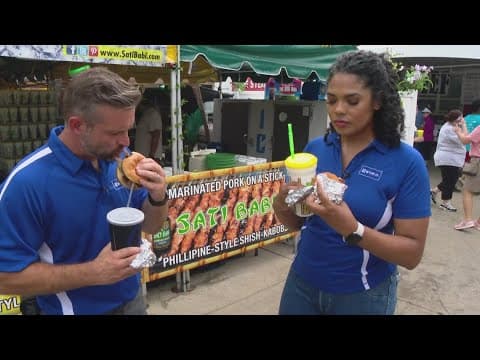 Dustin Grove and Felicia Lawrence taste-test food at the Indiana State Fair