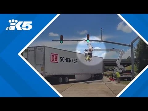 Worker knocked upside down by semi