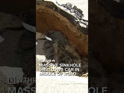 Massive sinkhole swallows car in middle of road | Via CNN
