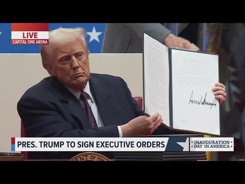 President Donald Trump signs executive orders before a crowd of vibrant supporters