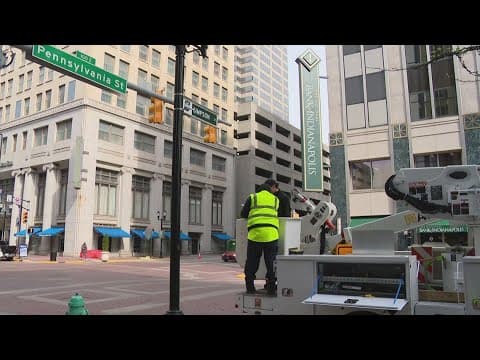 IndyCar drivers install street signs in downtown Indianapolis