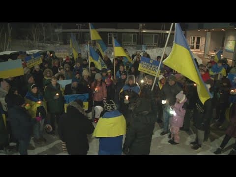 Hundreds march across Lowry Ave. bridge in solidarity with Ukraine one year later