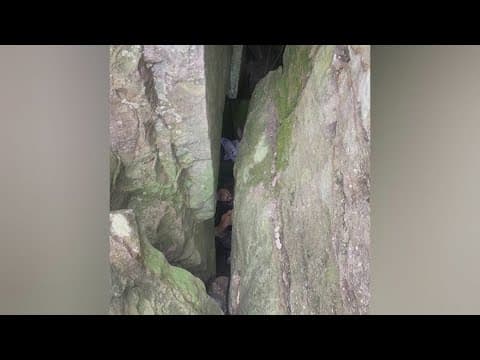 Woman stuck between 2 boulders for 7 hours after trying to reach dropped phone