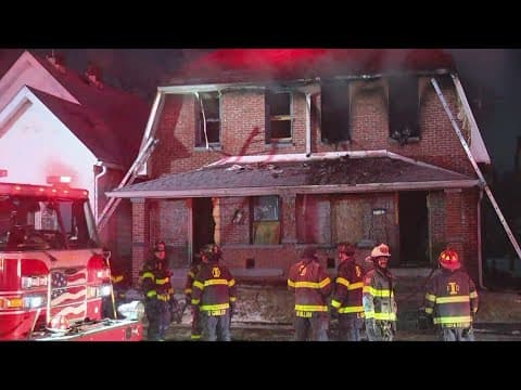 Car almost crashes into firefighters as they battle house fire in south Indy