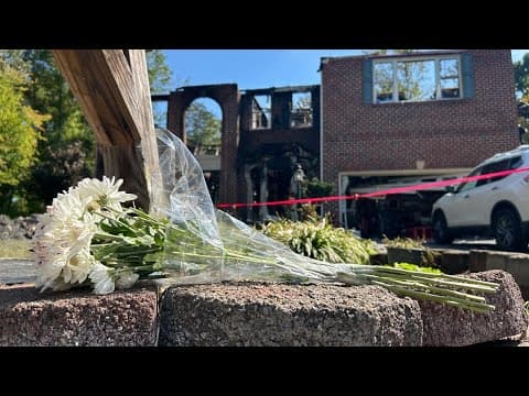 Flowers left in front of home where two children and a mother were killed in a fire