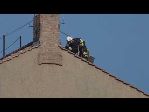 Vatican firefighters install a chimney on the roof of the Sistine Chapel for the papal election