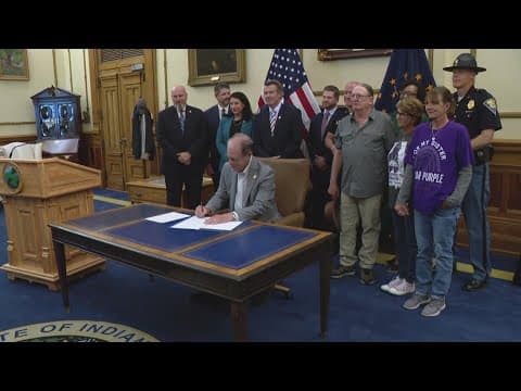 Family on hand as Indiana governor signs domestic violence provision into law