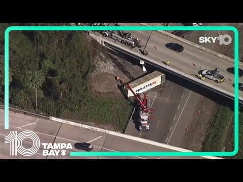 Woman hospitalized after semi-truck's trailer falls from overpass, hitting her Jeep