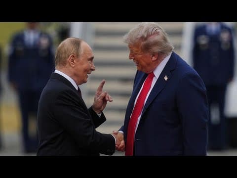 Donald Trump and Vladimir Putin shake hands after arriving in Alaska
