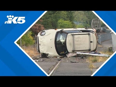 BREAKING: Car rolls over onto train tracks in Ballard