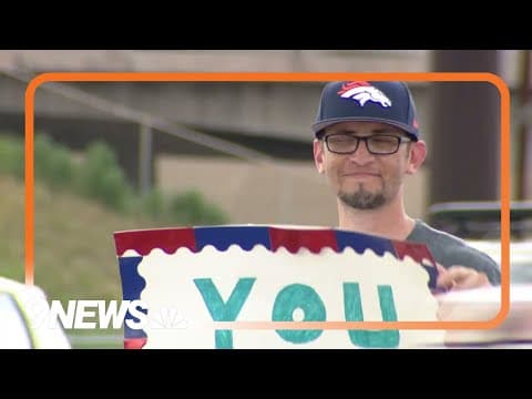 Man stands at intersection holding sign in memory of his sister | By our friend Corky Scholl