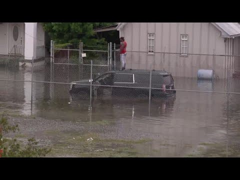 SUV trapped in flood, Man ends up on roof near Airline Drive