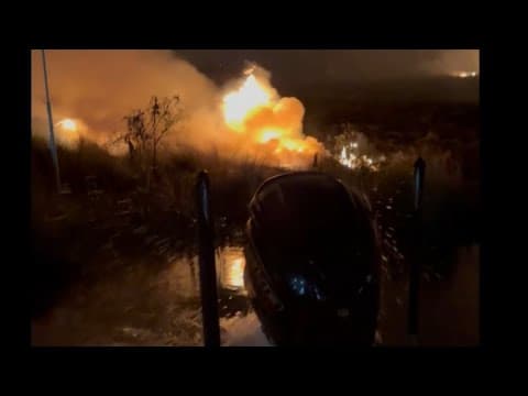 Man uses his boat's motor to save his home from a burning marsh fire in his backyard