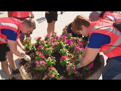 Volunteers plant flowers and clean up downtown Indy ahead of US Olympic Swim Trials