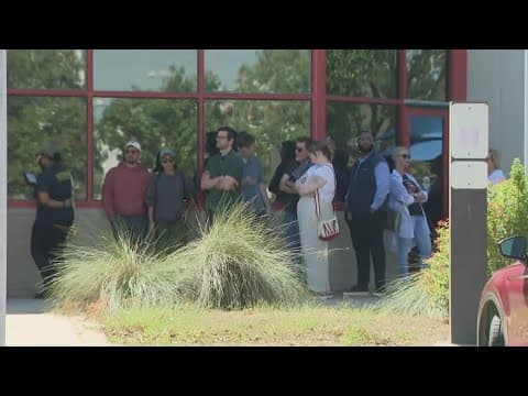 Voters line up as early voting gets underway in November election in the Houston area
