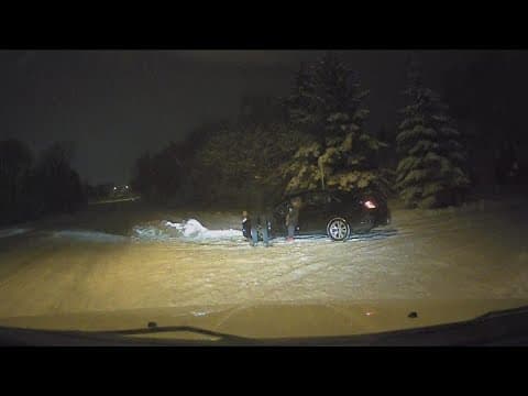 KARE 11 photographer Nate Anderson helps a driver stuck in the snow