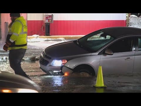 Woman drives into sinkhole after water main break on Indy's east side