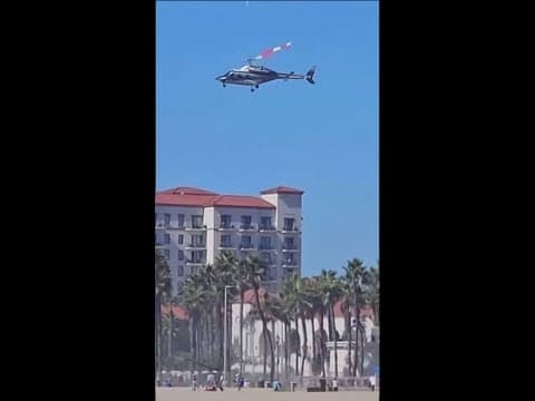 Southern California beachgoers watch helicopter spiral out of control, slam into palms
