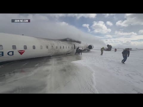 Rescue crews hose off Delta jet that flipped while trying to land in Canada